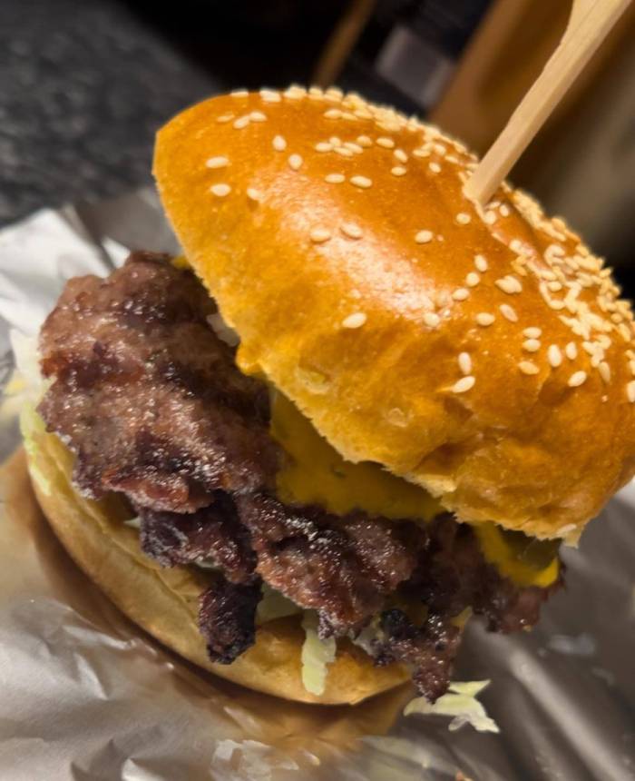 Smash N Grill Double Smash Burger with cheese, caramelised patties, and a sesame bun.